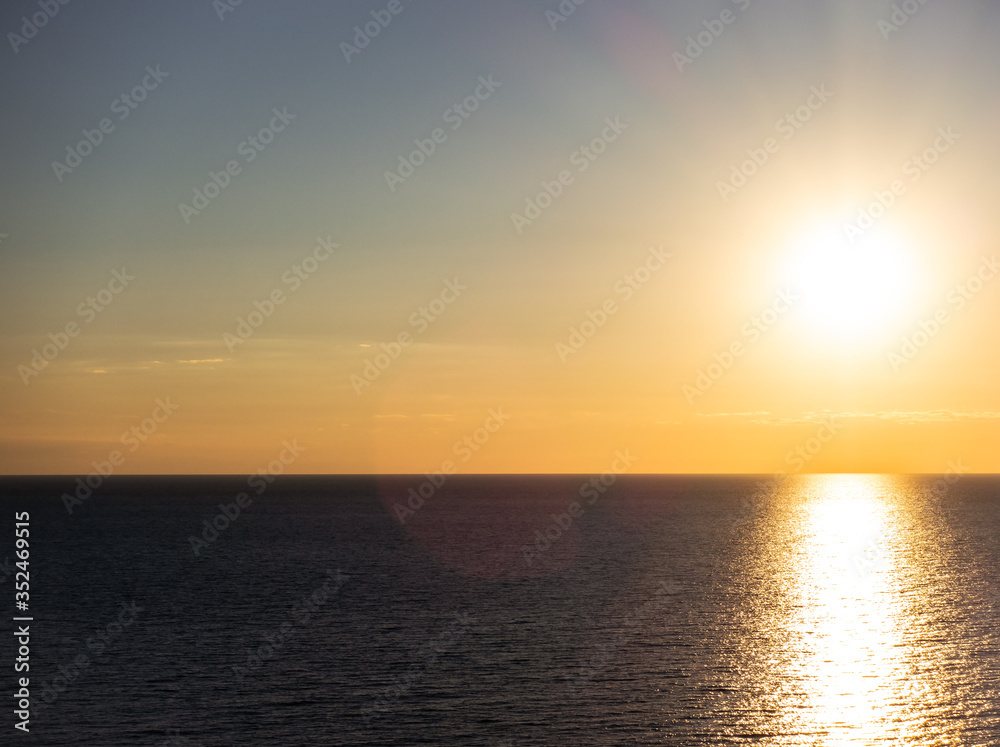 Calm, relaxing seascape. Background of the setting sun.