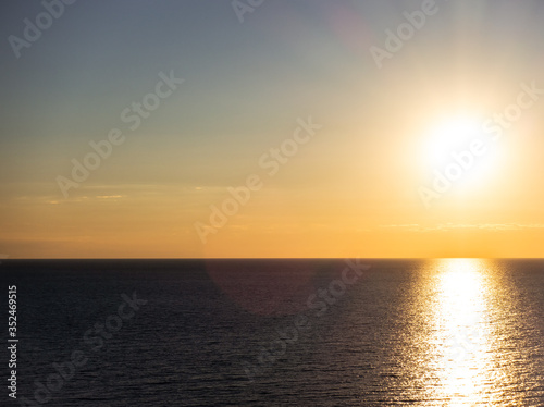 Calm, relaxing seascape. Background of the setting sun. © photosiber