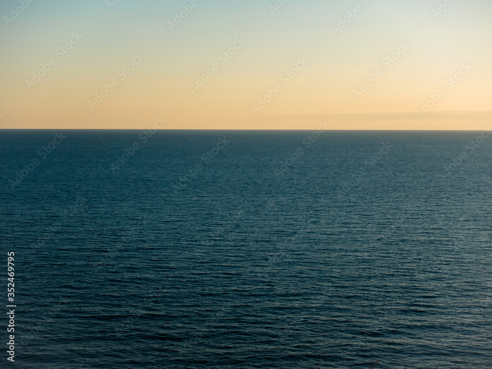 Calm, relaxing seascape. Background from the sunset sky and sea.