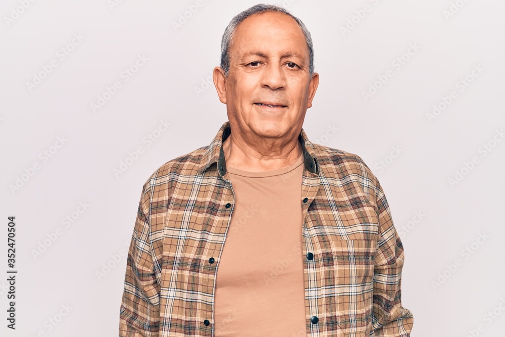 Senior man with grey hair wearing casual shirt with a happy and cool smile on face. lucky person.