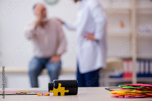 Doctor and patient suffering from Alzheimer disease photo