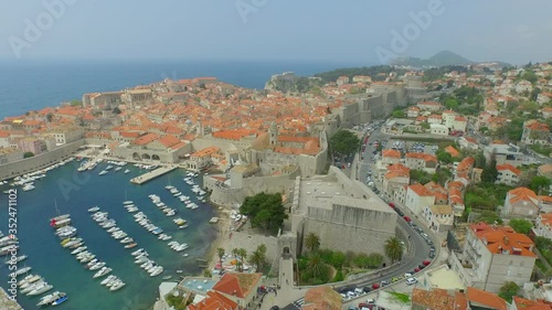 Aerial panning shot of old town by sea, drone is flying over ocean - Dubrovnik, Croatia photo