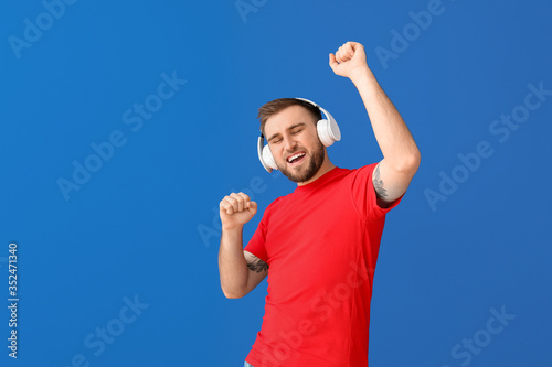 Handsome young man listenin...