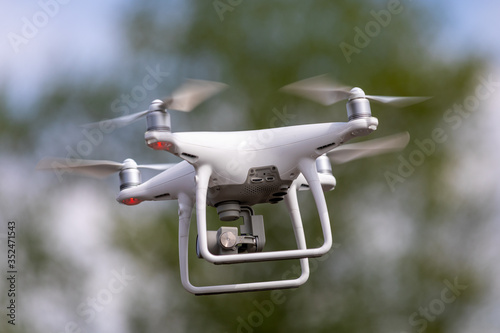 Drone quadrocopter with high resolution digital camera on the sky background.
