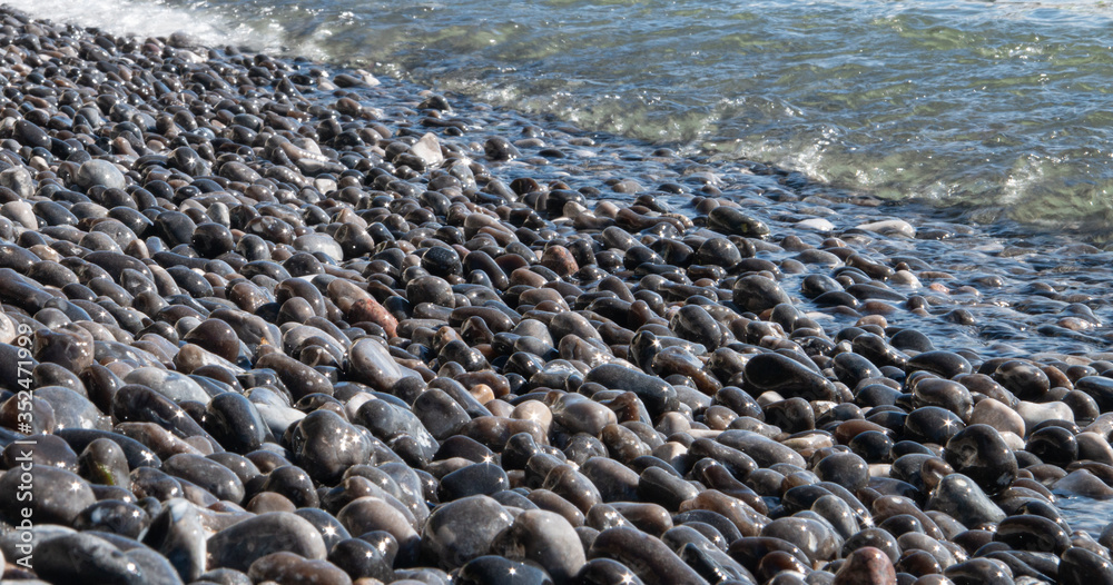 wet rocks laying in the water with sun stars wet rocks laying in the water with sun stars