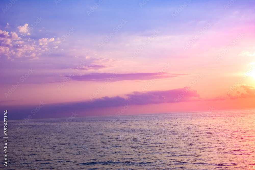Sunset at sea. The sun is hiding behind the clouds. Sunset at sea. The sun is hiding behind the clouds.