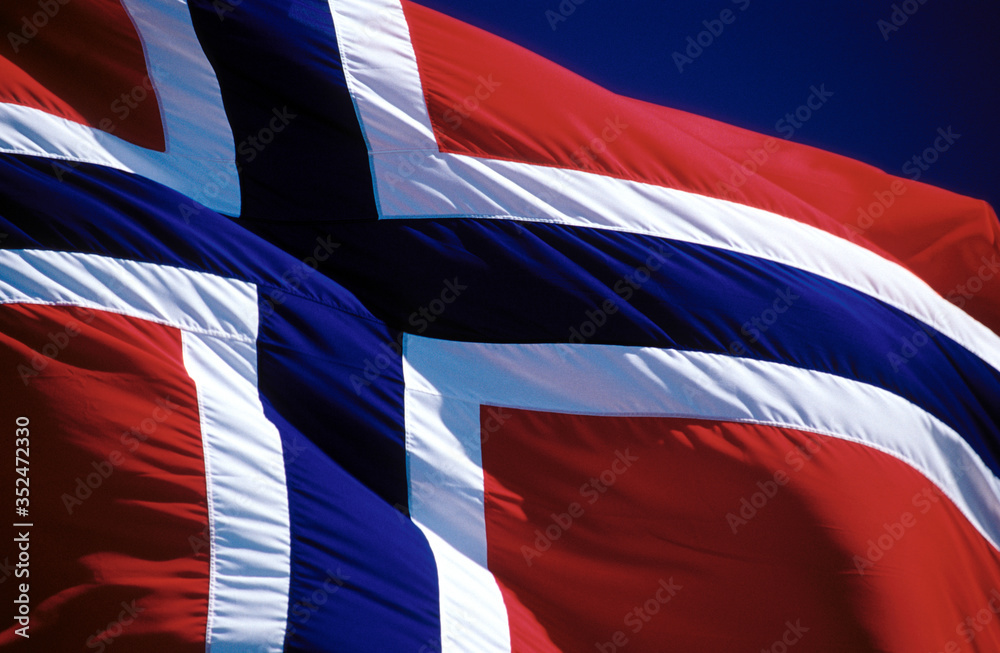 The Norwegian flag - large - waving in the wind during summer time The Norwegian flag - large - waving in the wind during summer time