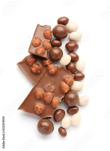 Tasty chocolate candies with nuts on white background