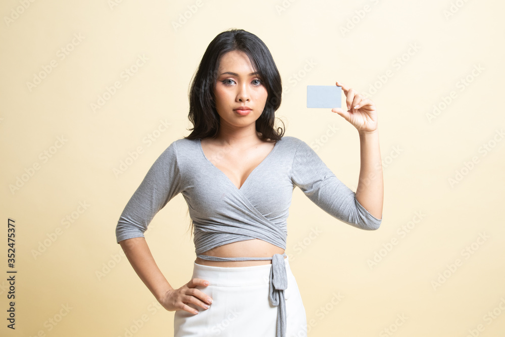 Young Asian woman with a blank card. Young Asian woman with a blank card.