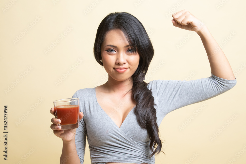 Strong healthy Asian woman with tomato juice. Strong healthy Asian woman with tomato juice.