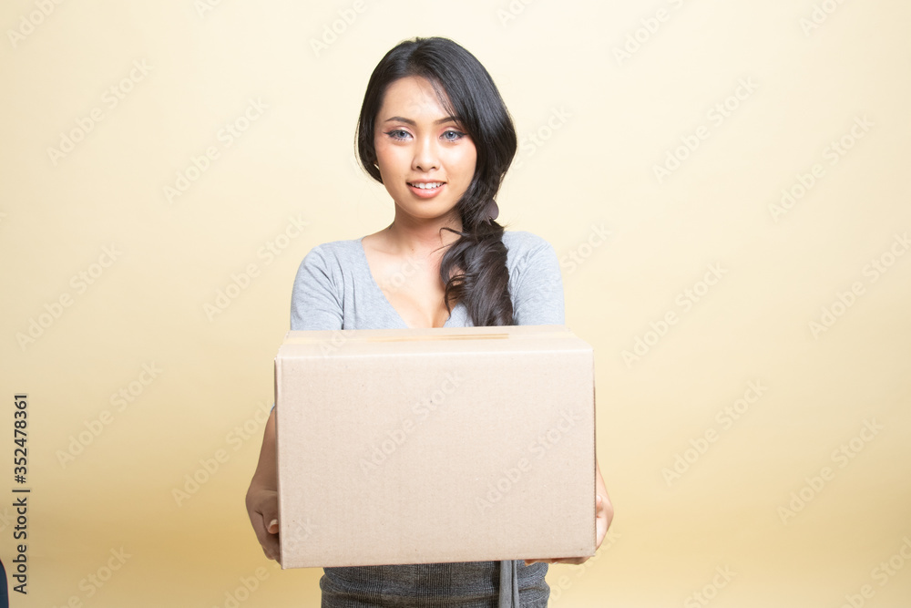 Delivery, relocation and unpacking. young asian woman holding cardboard box. Delivery, relocation and unpacking. young asian woman holding cardboard box.