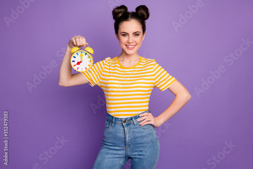 Portrait of her she nice attractive lovely pretty cute winsome content cheerful cheery girl holding in hand clock isolated bright vivid shine vibrant lilac violet purple color background
