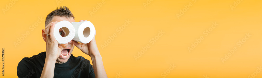 Φωτογραφία man looks through toilet paper in the hope of ending coronavirus covid-19