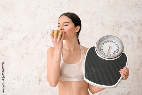 Young woman with measuring ...