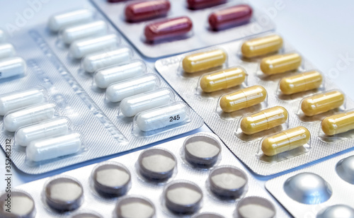 Various blisters with tablets on a medical table. Pills, medicine and health. Virus protection concept. 