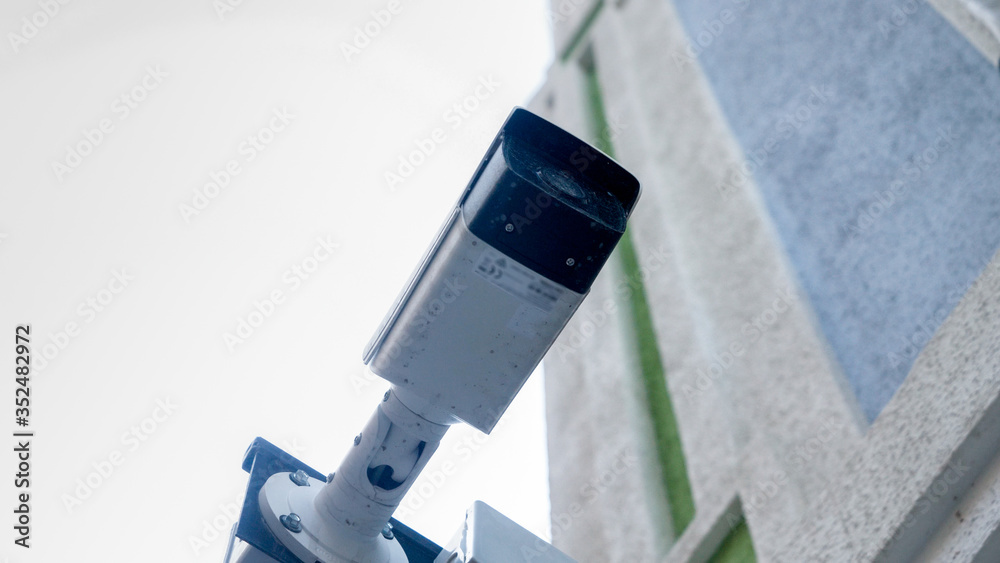 Fototapeta premium Closeup photo of surveillance camera installed on building side