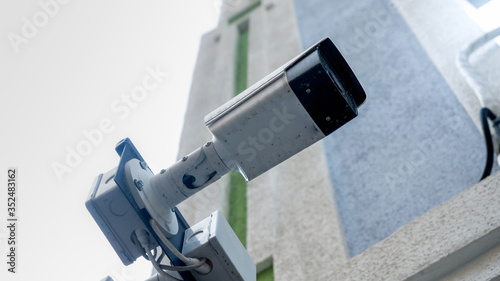 Modern electronic surveillance camera installed on city street