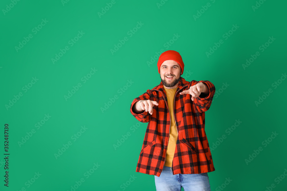 Handsome young man dancing against color background Handsome young man dancing against color background