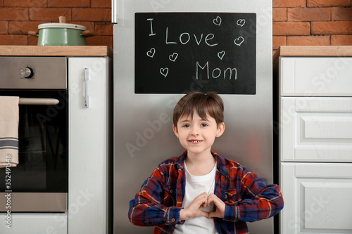 Little boy making heart sha...