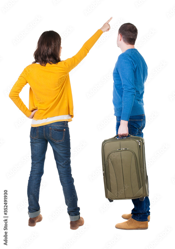 young couple in sweater traveling with suitcas.