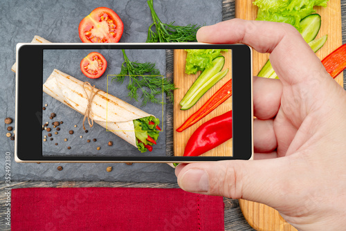 Vegetable roll on smartphone screen. Nutrition for healthy lifestyle. photo