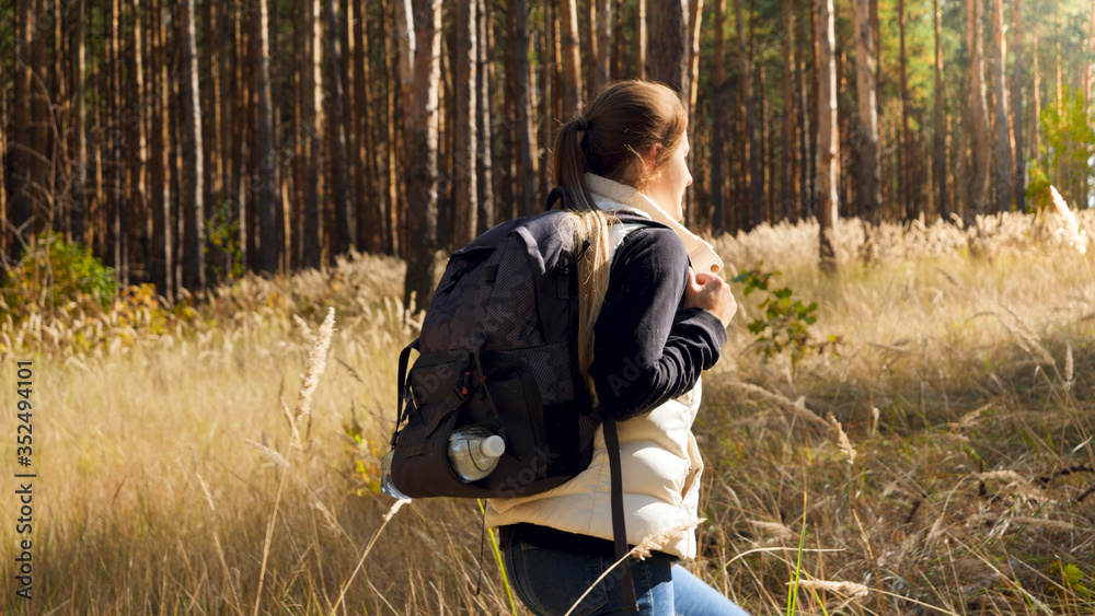 Beautiful young female tourist walking alone in pine tree forest Beautiful young female tourist walking alone in pine tree forest
