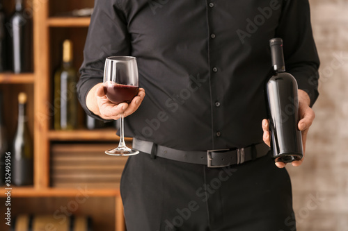 Sommelier holding red wine ...
