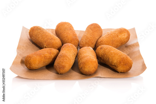 Spanish croquettes on paper isolated on white background