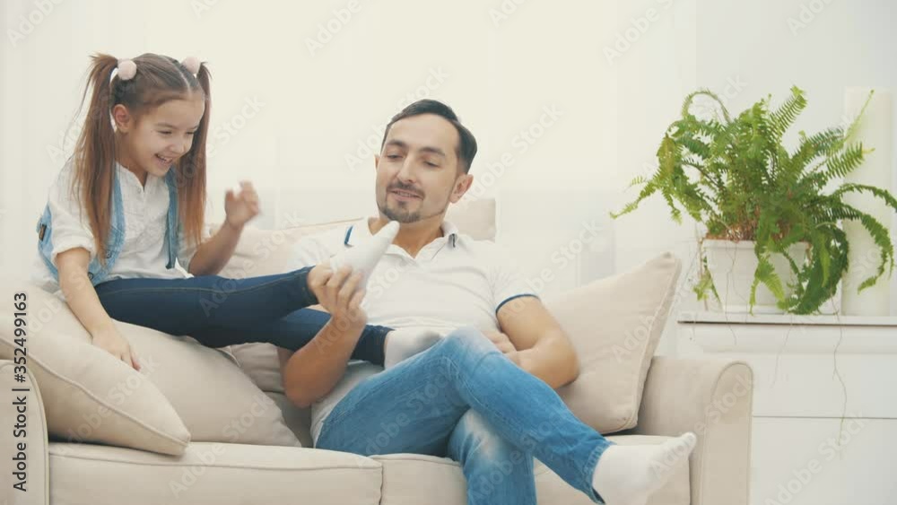 4k slowmotion video where happy beautiful family playing on sofa at home. 4k slowmotion video where happy beautiful family playing on sofa at home.