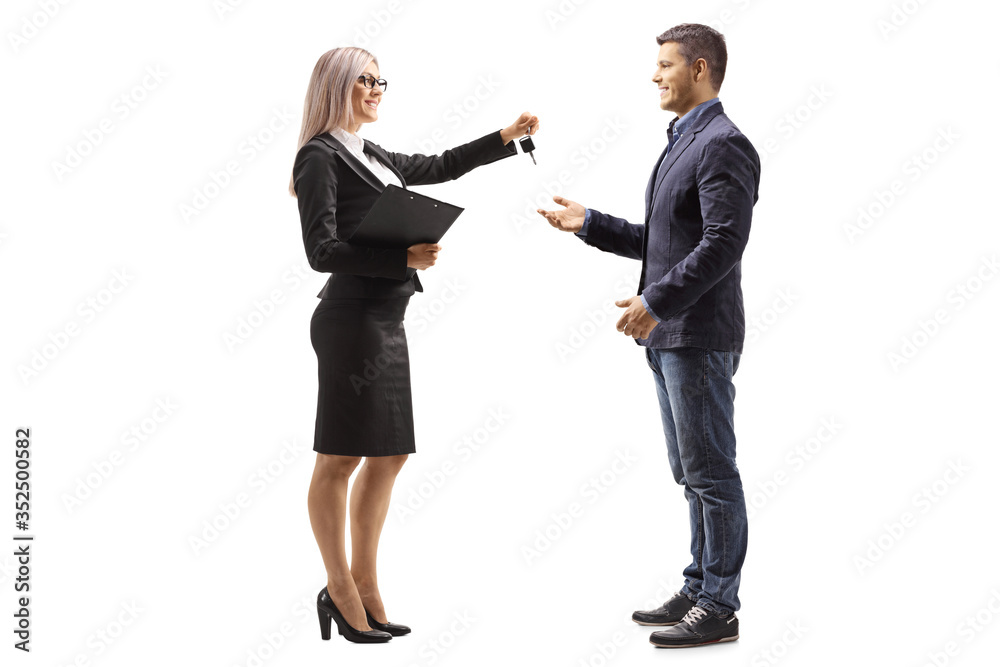 Professional woman giving car keys to a man Professional woman giving car keys to a man
