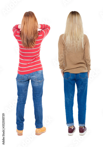 Back view of two woman in sweater.