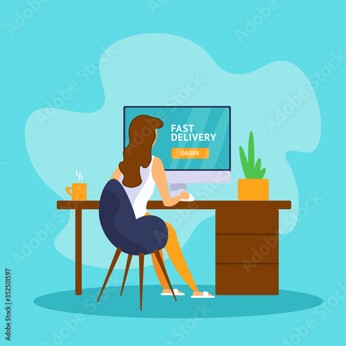 Young woman sitting at a computer and ordering home delivery in the online store