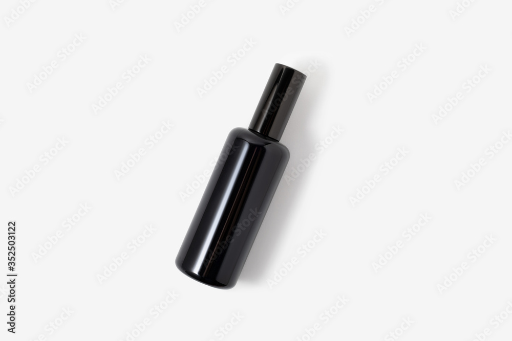Black glass cosmetic or parfum spray bottle on white background. Face, body skin or hair care. Health and beauty Black glass cosmetic or parfum spray bottle on white background. Face, body skin or hair care. Health and beauty