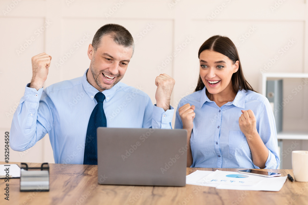 Businessman And Businesswoman Shaking Fists Celebrating Business Success In Office Businessman And Businesswoman Shaking Fists Celebrating Business Success In Office