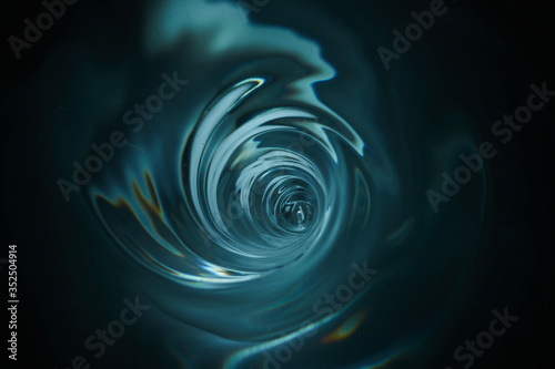 Smooth and beautiuful blue vortex. Whirlpool, water swirl, top view. High speed liquid photography.