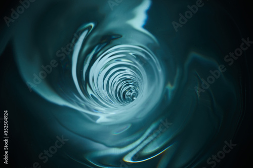Smooth and beautiuful blue vortex. Whirlpool, water swirl, top view. High speed liquid photography.