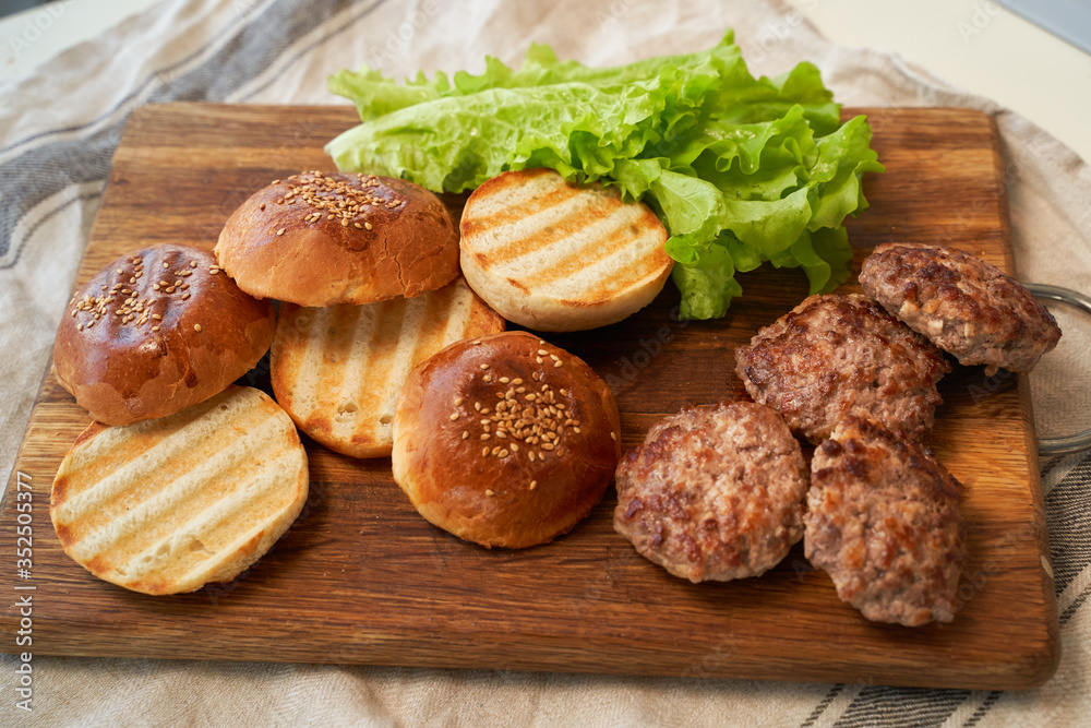Fototapeta premium Fresh homemade burger buns with sesame seeds.