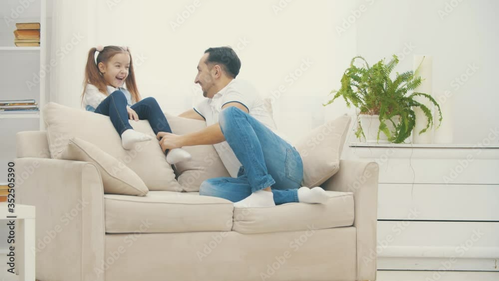 4k slowmotion video where father and little child play, laugh and hug together. 4k slowmotion video where father and little child play, laugh and hug together.