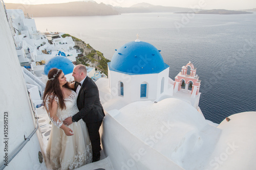 Wedding couple on the background architecture of Santorini.