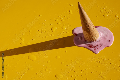 фотографія Strawberry ice cream cone upside down and melted.