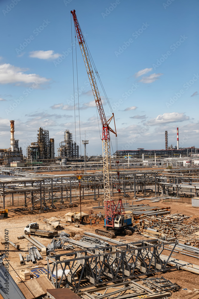 Construction site of an oil refinery with a large number of preformed pipeline par