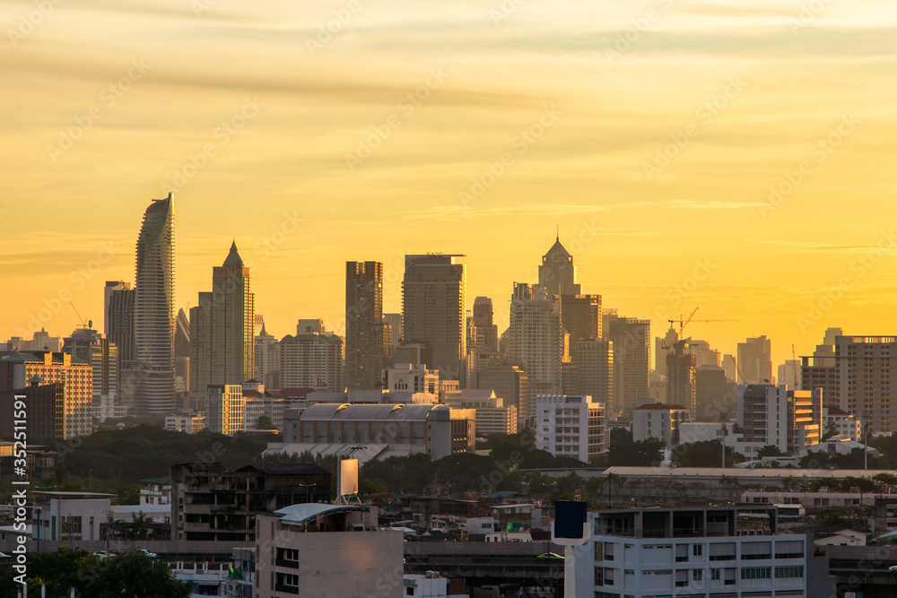 Fototapeta premium Aerial view modern office buildings in Bangkok city downtown with sunrise time