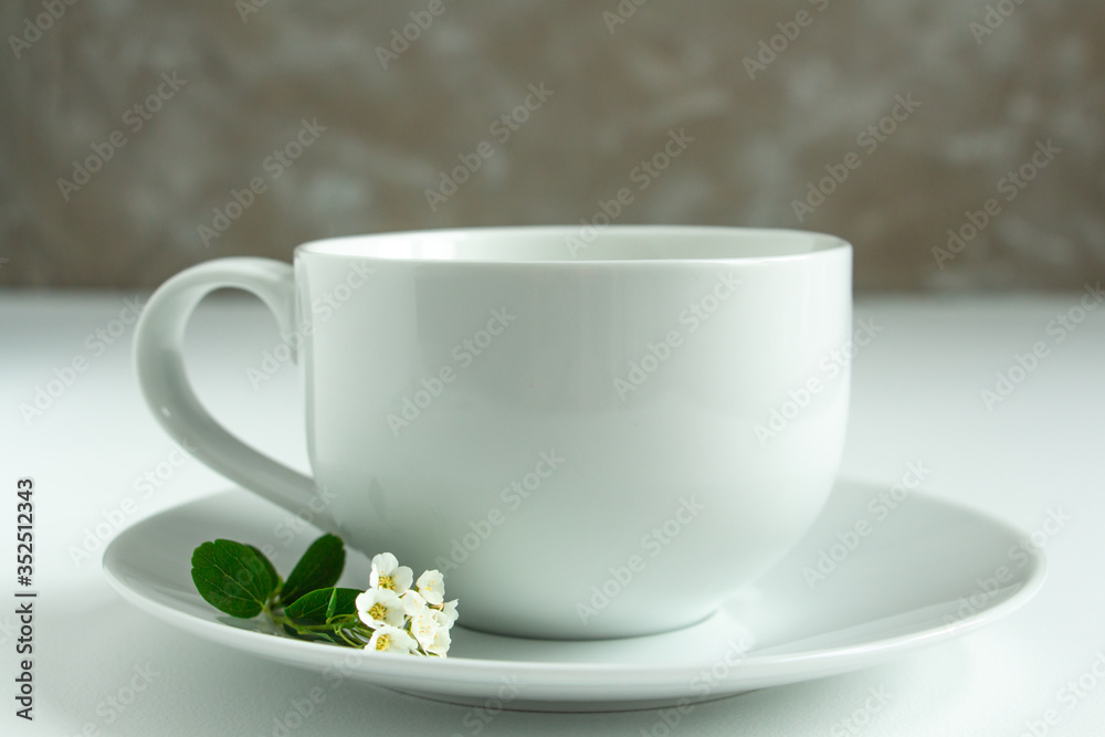 a white cup of fresh milk on a white background with sprigs of white flowers that complement the composition, tasty, healthy, atmospheric a white cup of fresh milk on a white background with sprigs of white flowers that complement the composition, tasty, healthy, atmospheric
