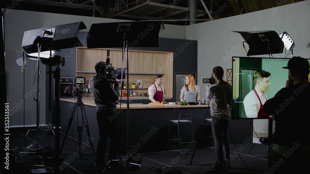 WIDE Behind the scenes of studio set, shooting TV television cooking show featuring celebrity chef, professional TV production