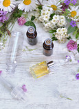 essential oil and freshness  flowers in bottle on  a table