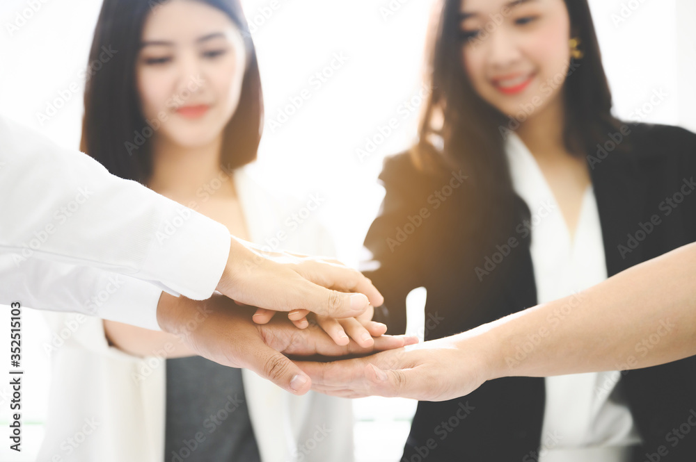 Close up beautiful young businesswoman people putting their hands together. Stack of hands. Unity and teamwork concept. Close up beautiful young businesswoman people putting their hands together. Stack of hands. Unity and teamwork concept.