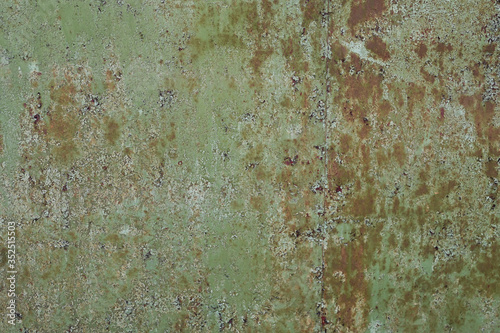 old orange metal wall in green