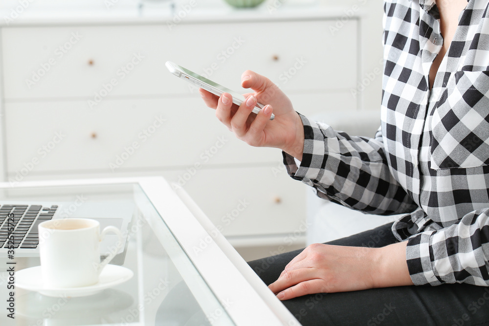Young woman using mobile phone at home Young woman using mobile phone at home