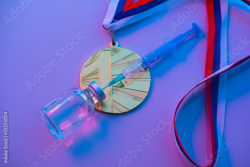 Fototapeta Naklejka Na Ścianę i Meble -  Doping in Sport, concept photo, syringe, medical ampoule and gold medal