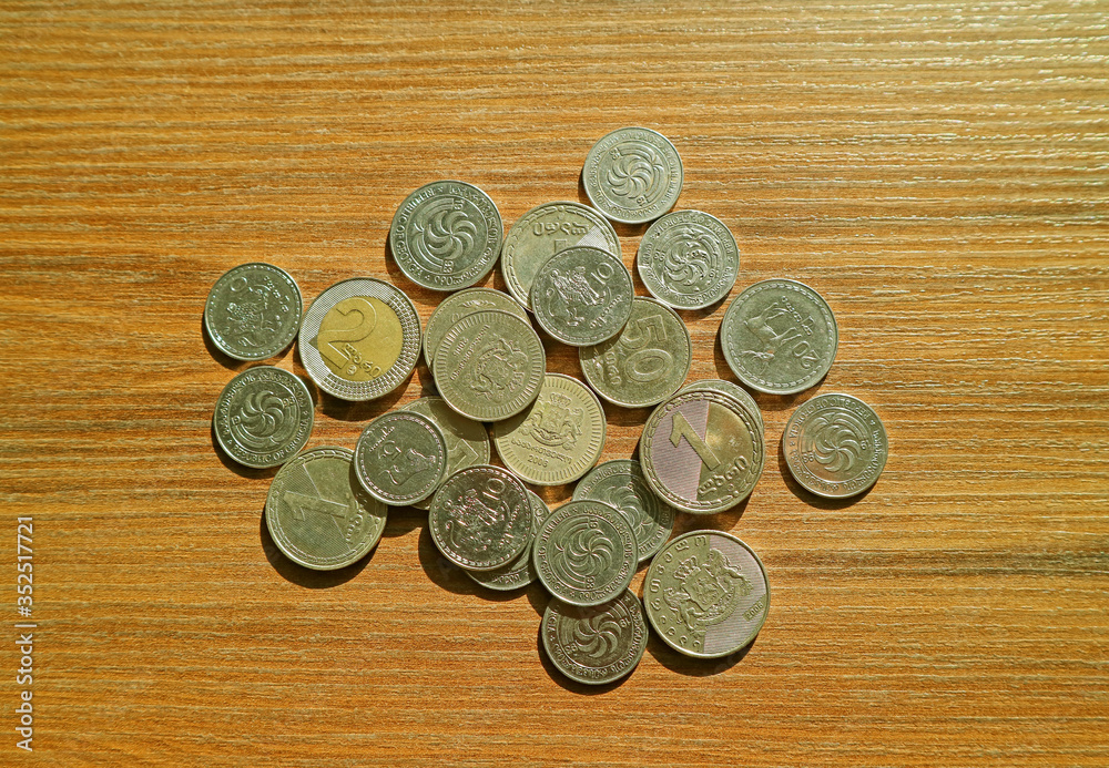 Top View of Heap of Georgian Lari and Tetri Coins on Wooden Background Top View of Heap of Georgian Lari and Tetri Coins on Wooden Background